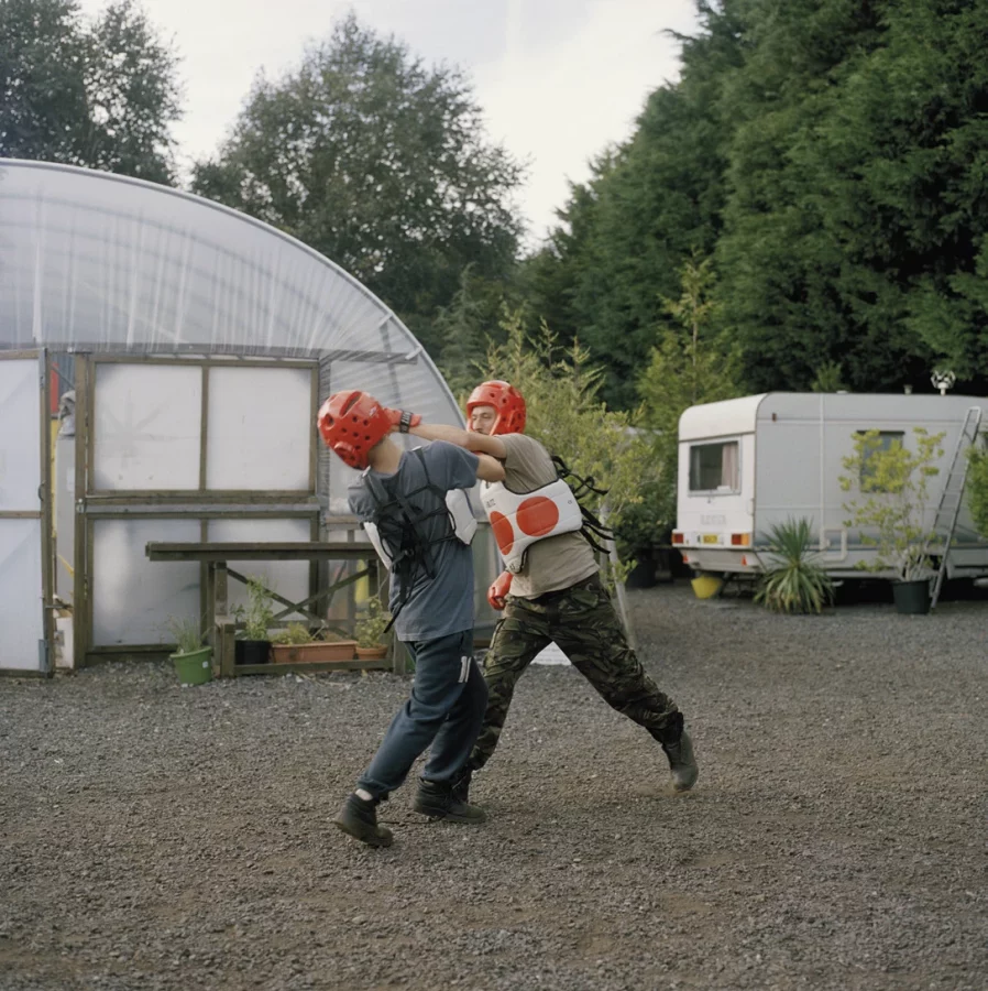 Rhiannon Adam. <em>Eck and Tom playfighting at Maple Farm</em>, from <em>The Rift – Fracking in the UK</em> series, 2018. Courtesy of the artist and The British Journal of Photography, London.